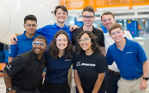 group photo of several young people smiling and wearing Boeing shirts