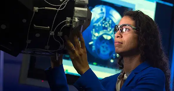 Female engineer inspecting a piece of aerospace machinery