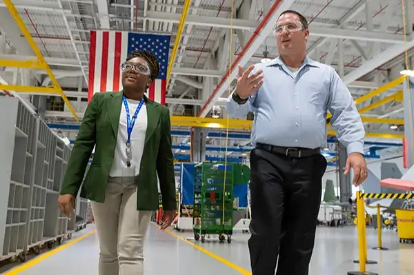 employee being given a guided tour of a warehouse facility