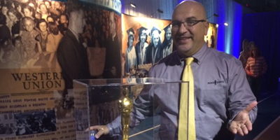 man standing behind display case