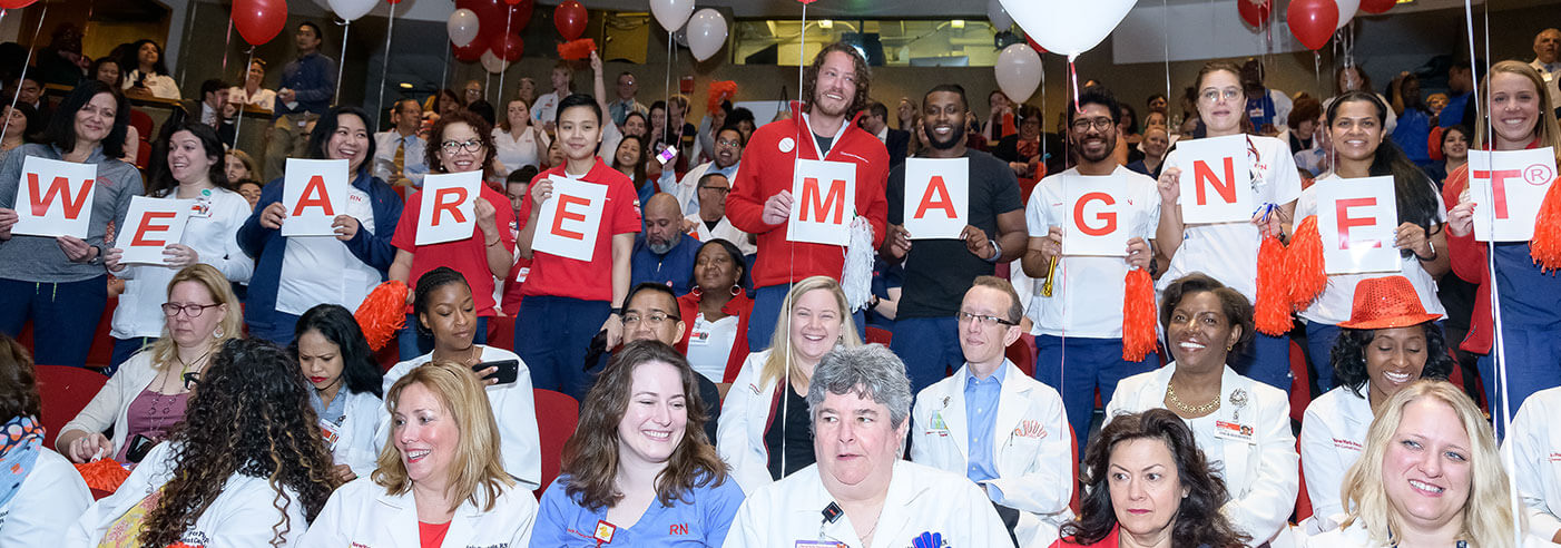 Group of people with We Are Magnet sign