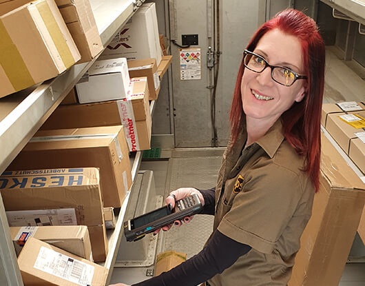 Stefanie - smiling while scanning a package