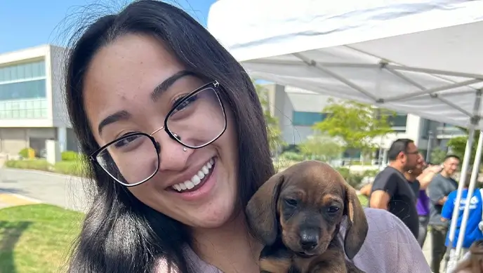 Employee holding puppy