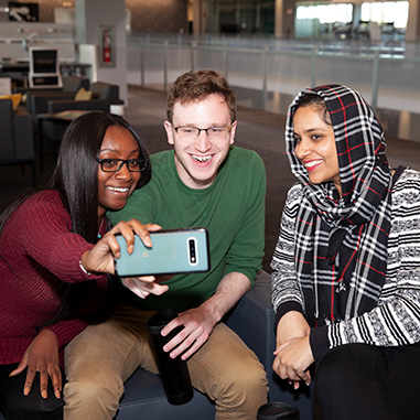 Three people taking a selfie