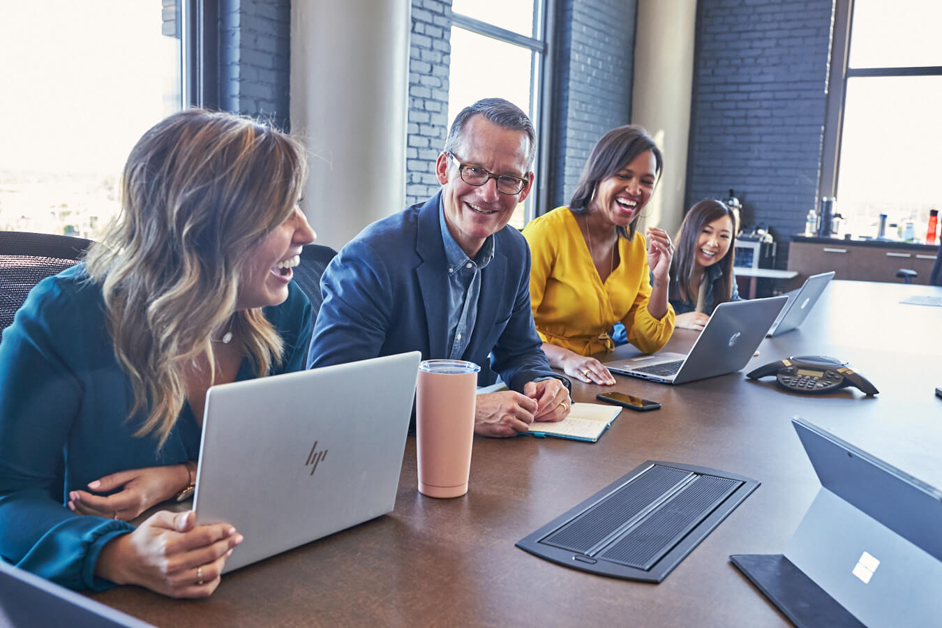 A group of four people brainstorming in a conference room