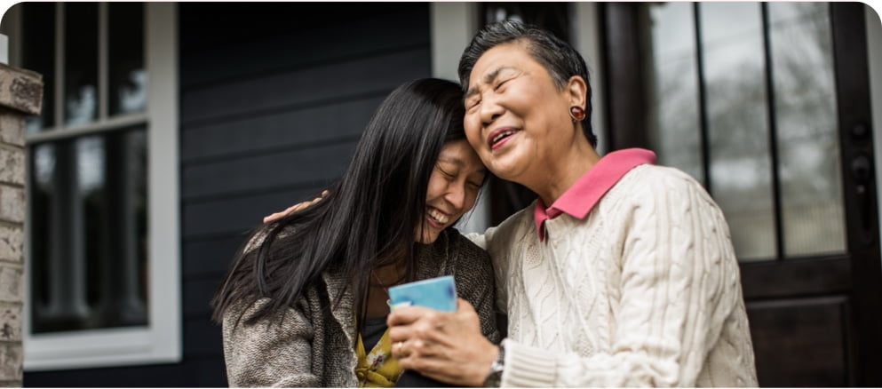 Image of women smiling and hugging each other