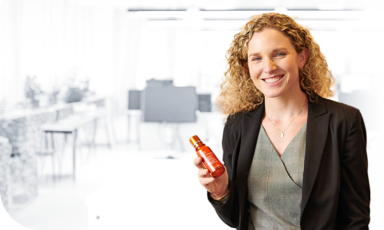 Female employee in the office smiling for a picture