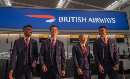 People smiling in front of British Airways banner