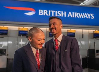 People smiling in front of British Airways banner