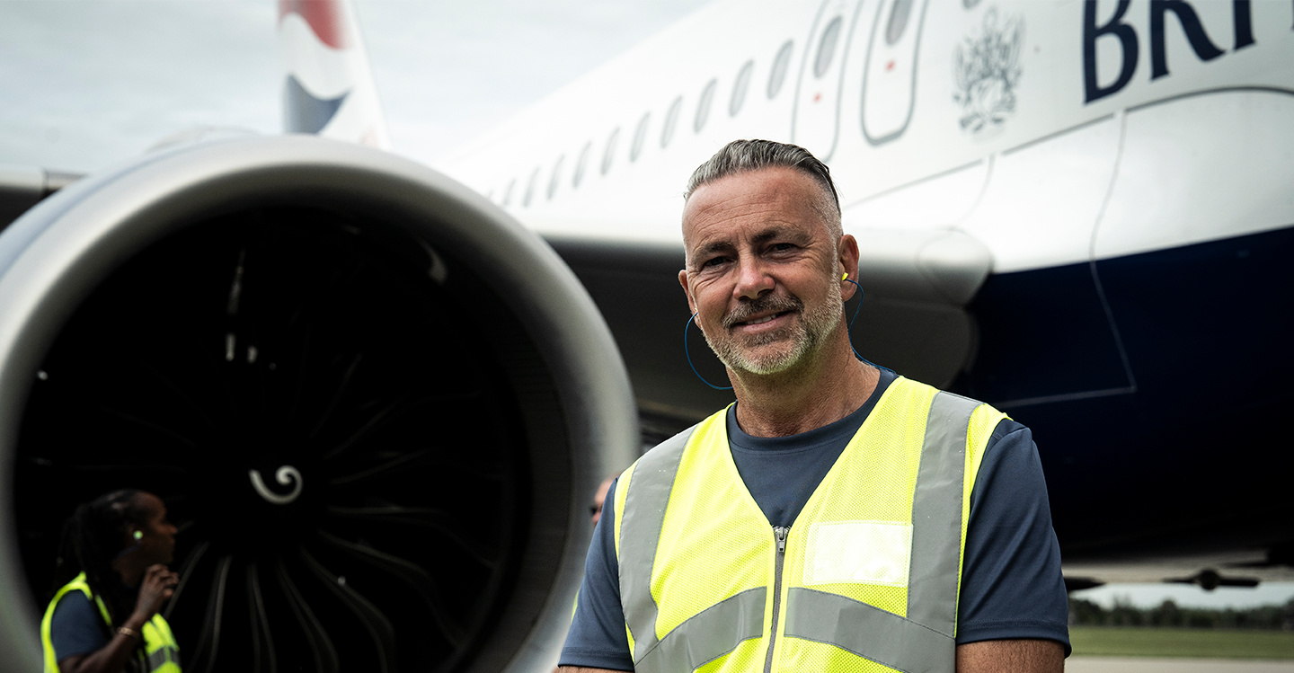 a male employee in front of an airplane