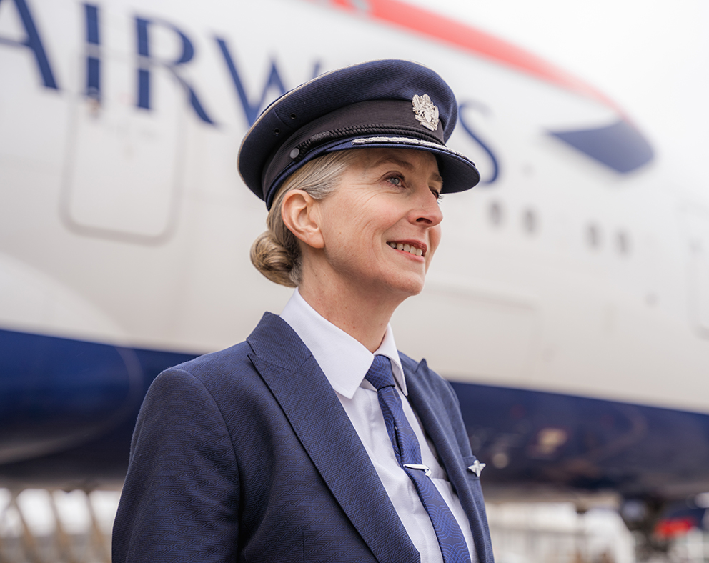 Female British Airway Pilot in uniform standing in front of a British Airways aircraft