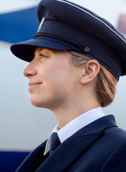 Two Pilots smiling and walking side by side into Heathrow Terminal 5