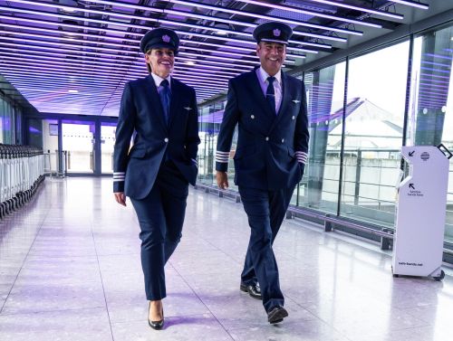 Pilot at terminal walking in uniform