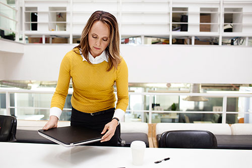 Picture of a woman sitting down at a meeting room table