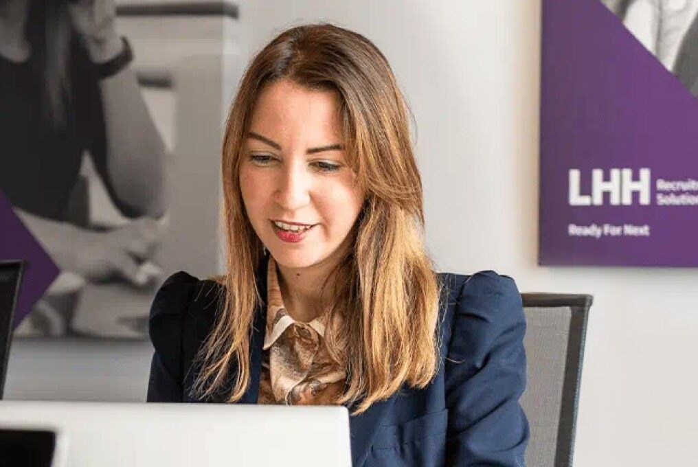 A woman sitting at her desk