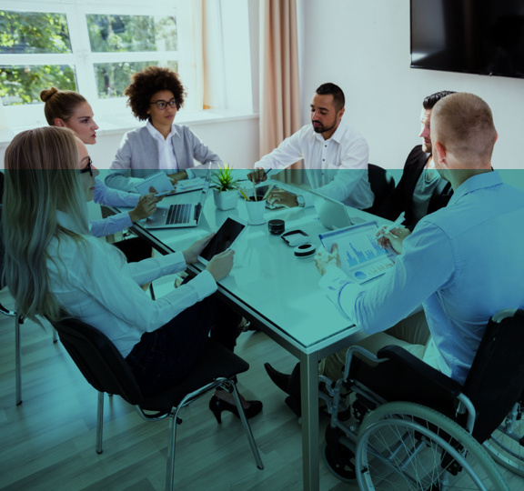 A group of friends sitting around a table and discussion with each other.