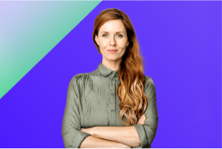 Smiling woman with red hair in gray shirt