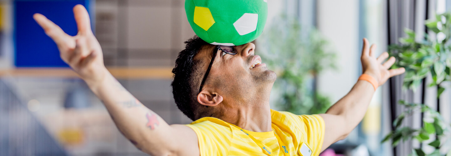 Ikea staff member balancing a ball on his head