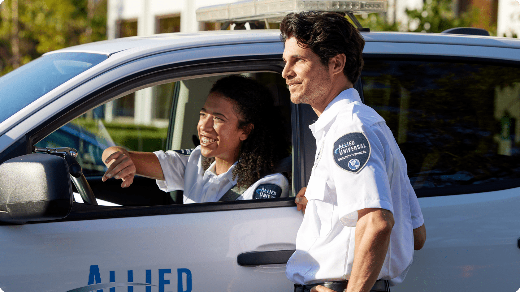 Security officer speaking with a driver at a vehicle checkpoint