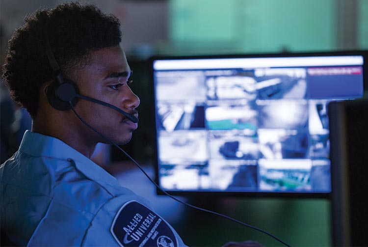 A security professional in front of a computer monitor