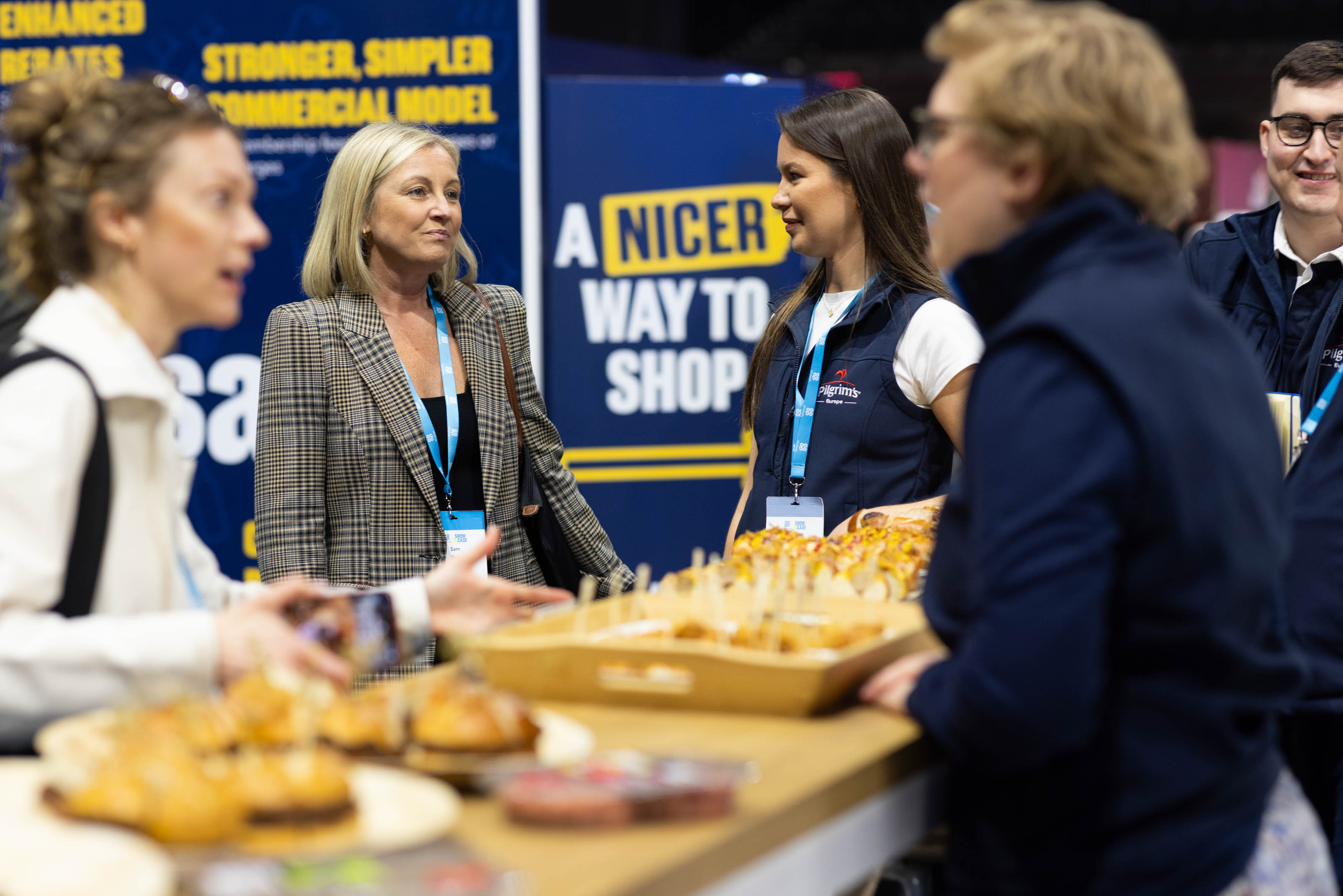 Wholesale colleagues talking to vendors at their annual expo