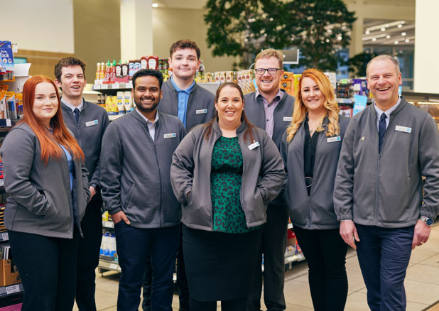 Group of employees wearing Co-op uniforms in a retail setting