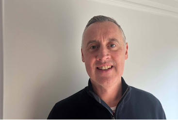 Andrew Lowe sharing his work story at office.