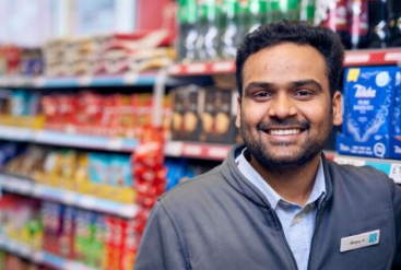 Smiling man standing in front of grocery store shelves