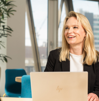 Lady smiling infront of Laptop