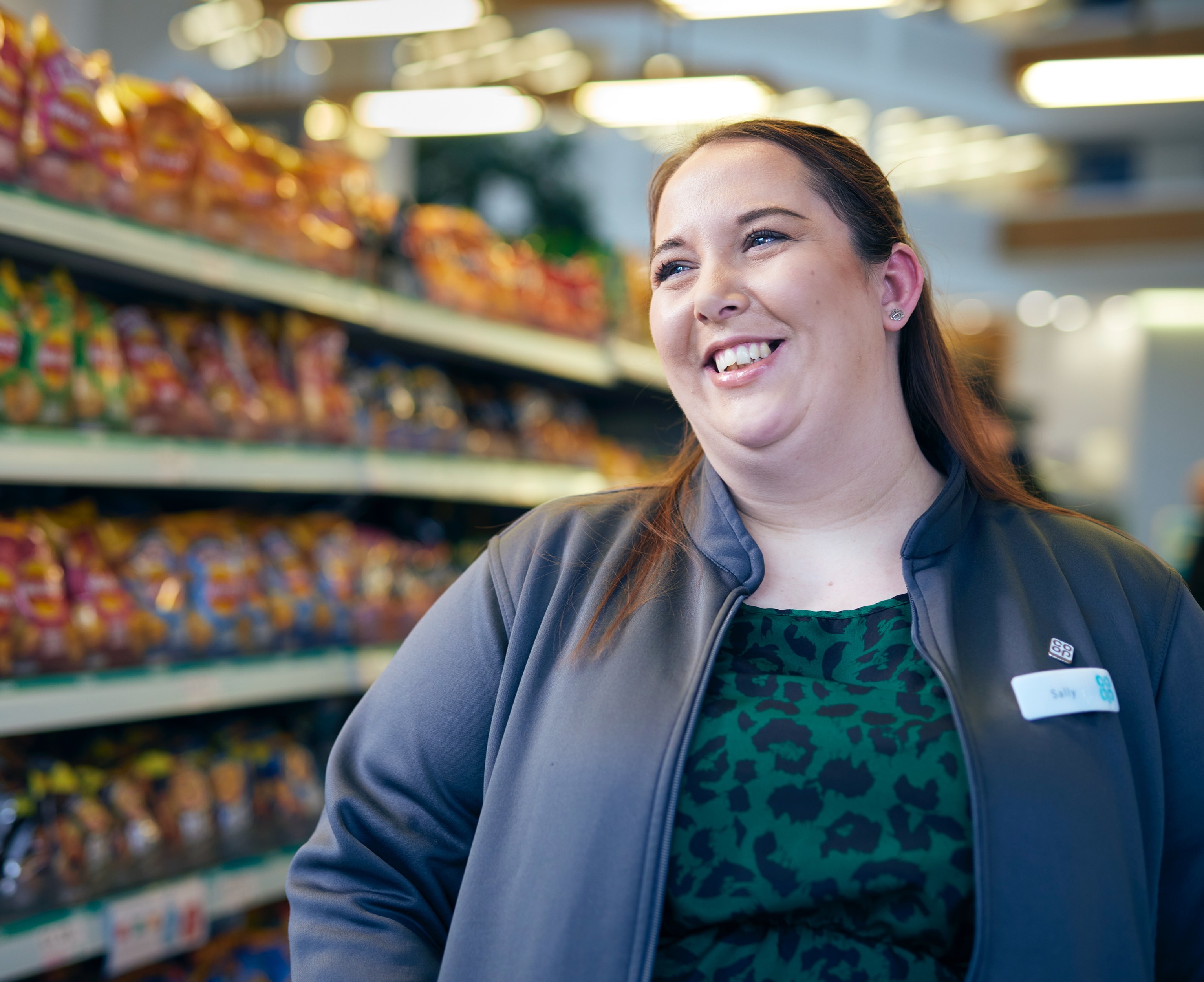 Red-haired woman smiling in store