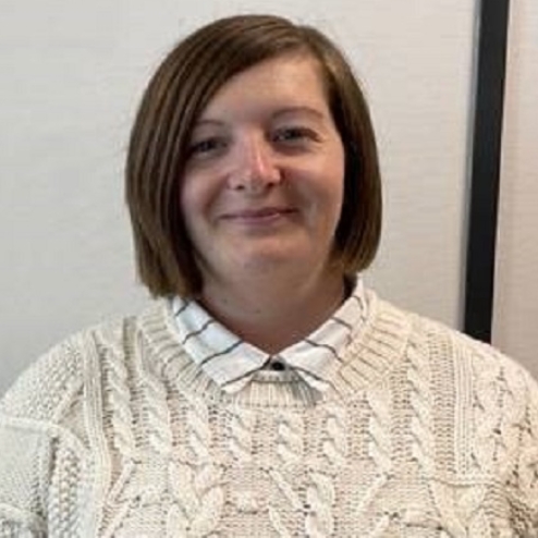 Smiling woman in sweater at Biggleswade office.