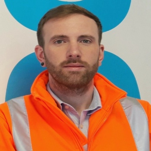Man in orange jacket at Co-op Biggleswade site.