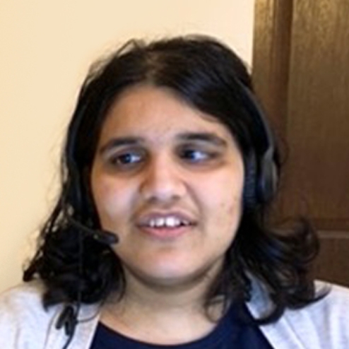 Blind woman smiling while wearing a headset.