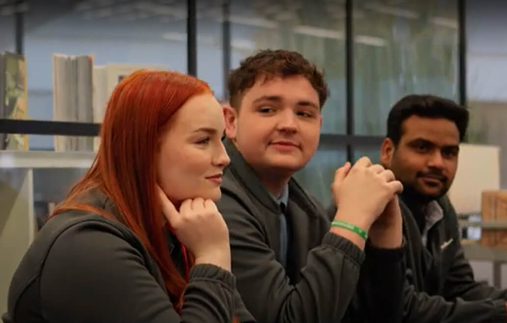 Group of employees wearing Co-op uniforms in a retail setting