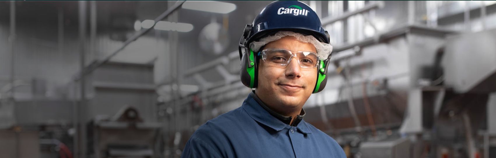 Cargill plant employee with ear protection