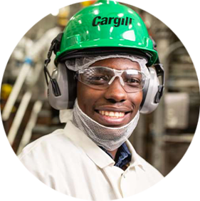 A black man wearing glasses and a white Cargill hardhat.