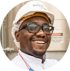 A black man wearing glasses and a white Cargill hardhat.