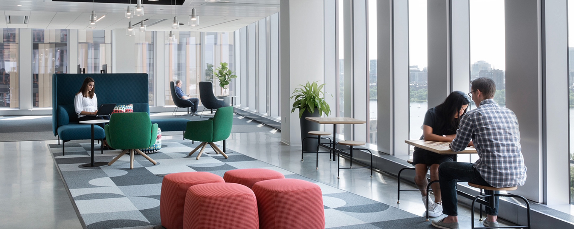 Two Capital One associates sit across a table in Capital One's Boston office