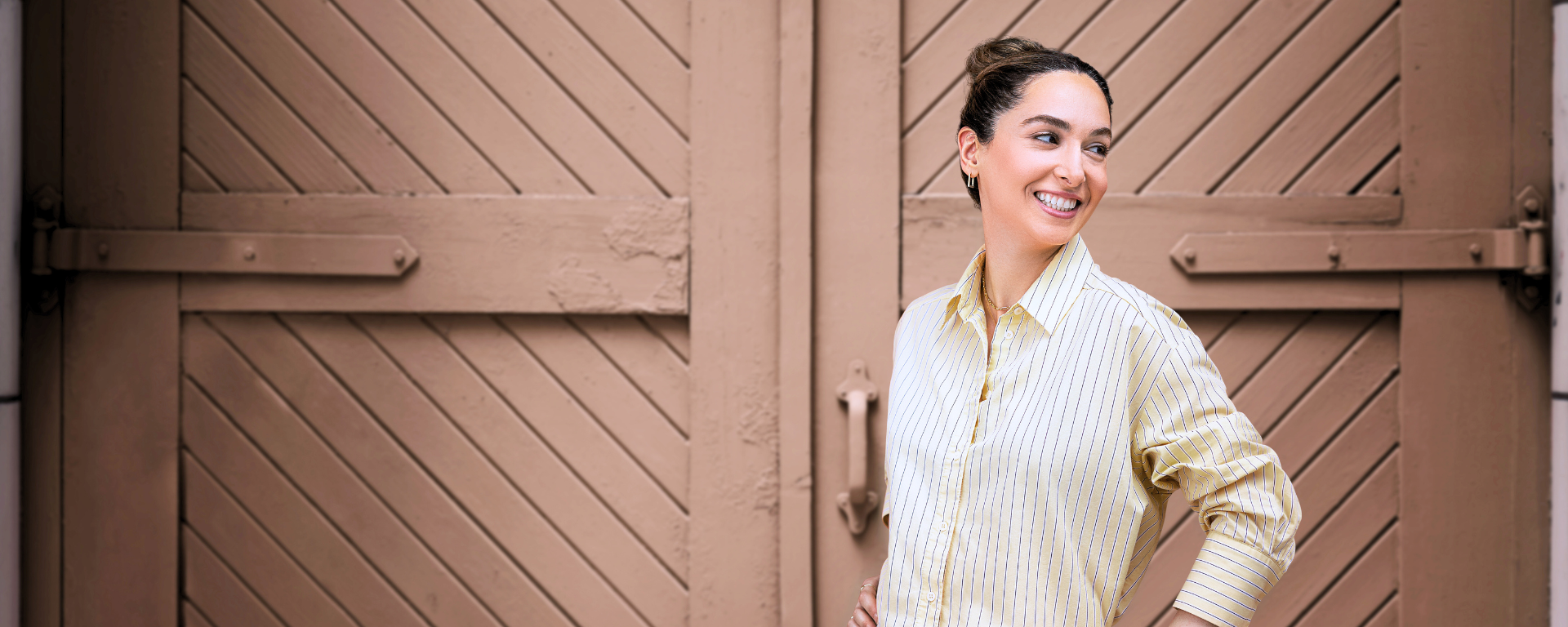 Capital One associate smiling in with hand on hip