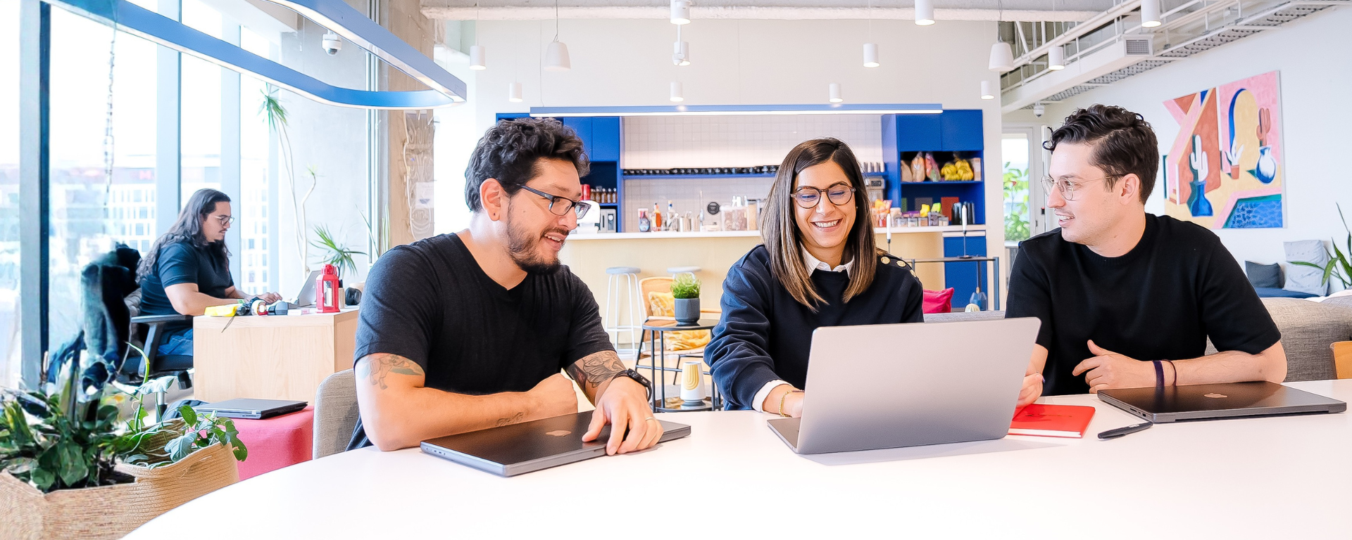 Capital One employees collaborating with a laptop open