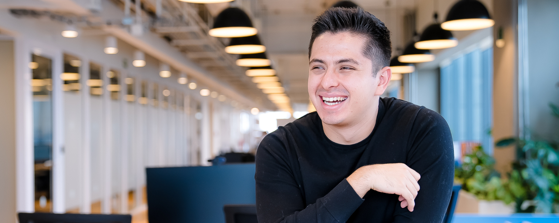 Capital One associate laughing at desk