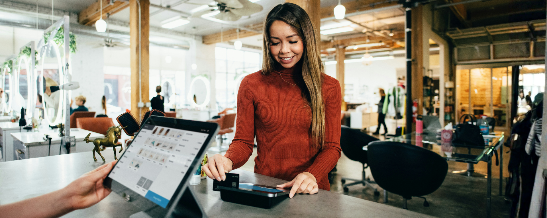 Capital One associate pointing to peer's monitor