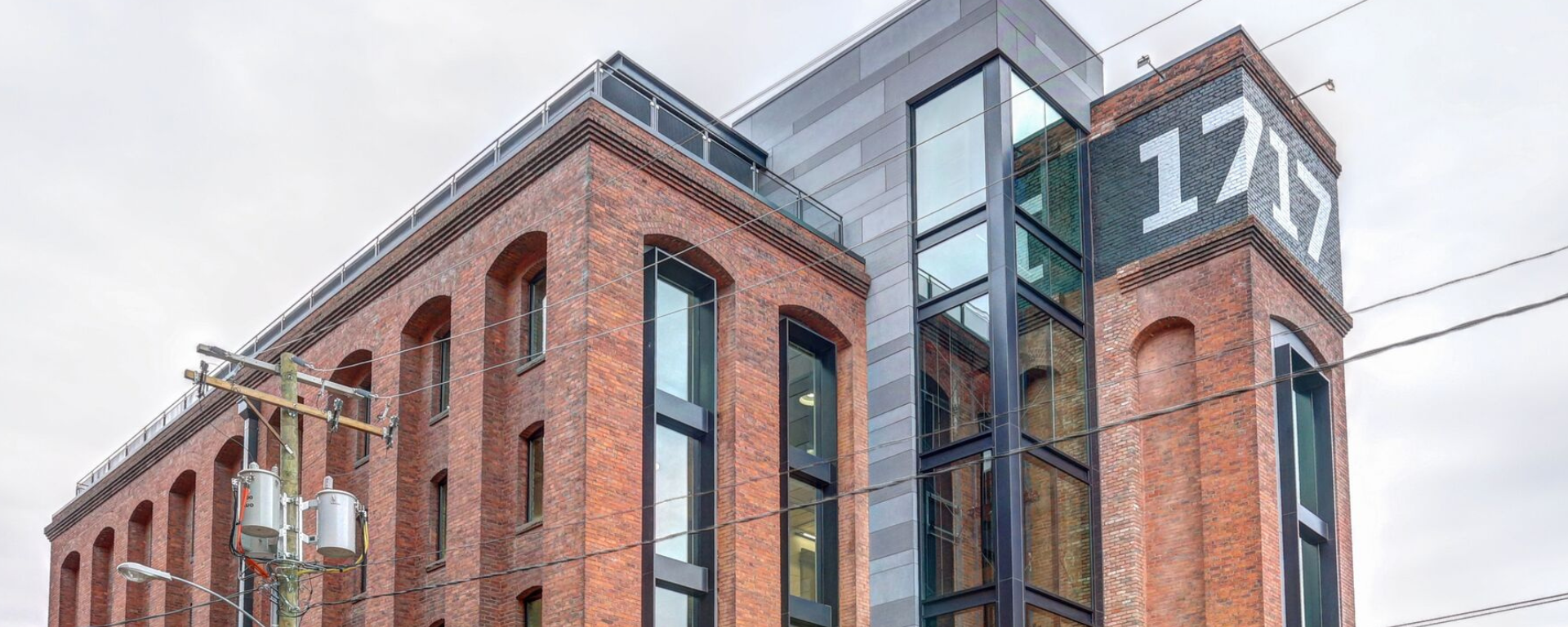 A photo of the 1717 Michael Wassmer Innovation Center against a cloudy sky