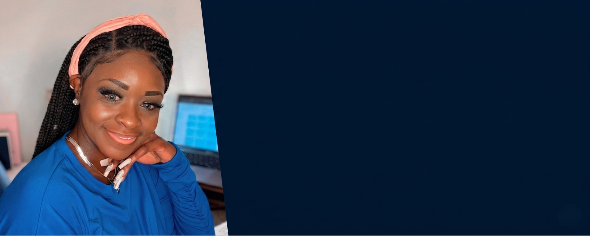 Monica S., Capital One associate, smiles at the camera in front of her computer, with a dark blue background
