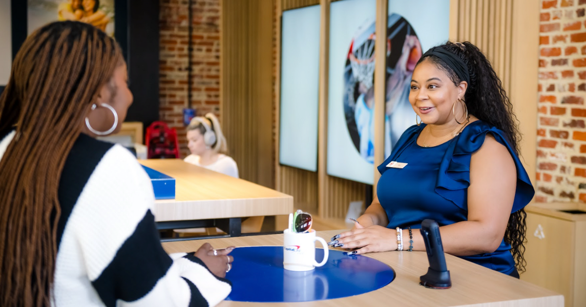 A Capital One cafe associate helps a customer