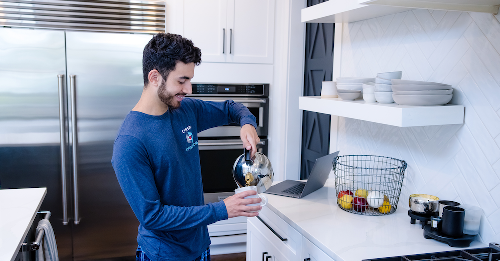 Capital One associate works from home and pours coffee