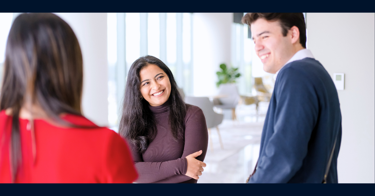 3 Capital One associates standing and laughing together