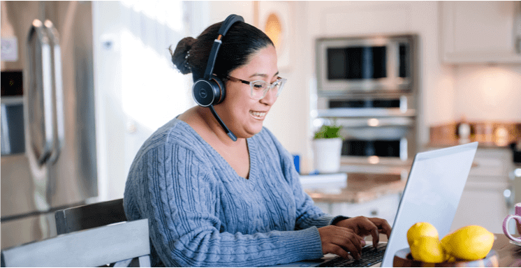 woman working at laptop in her kitchen