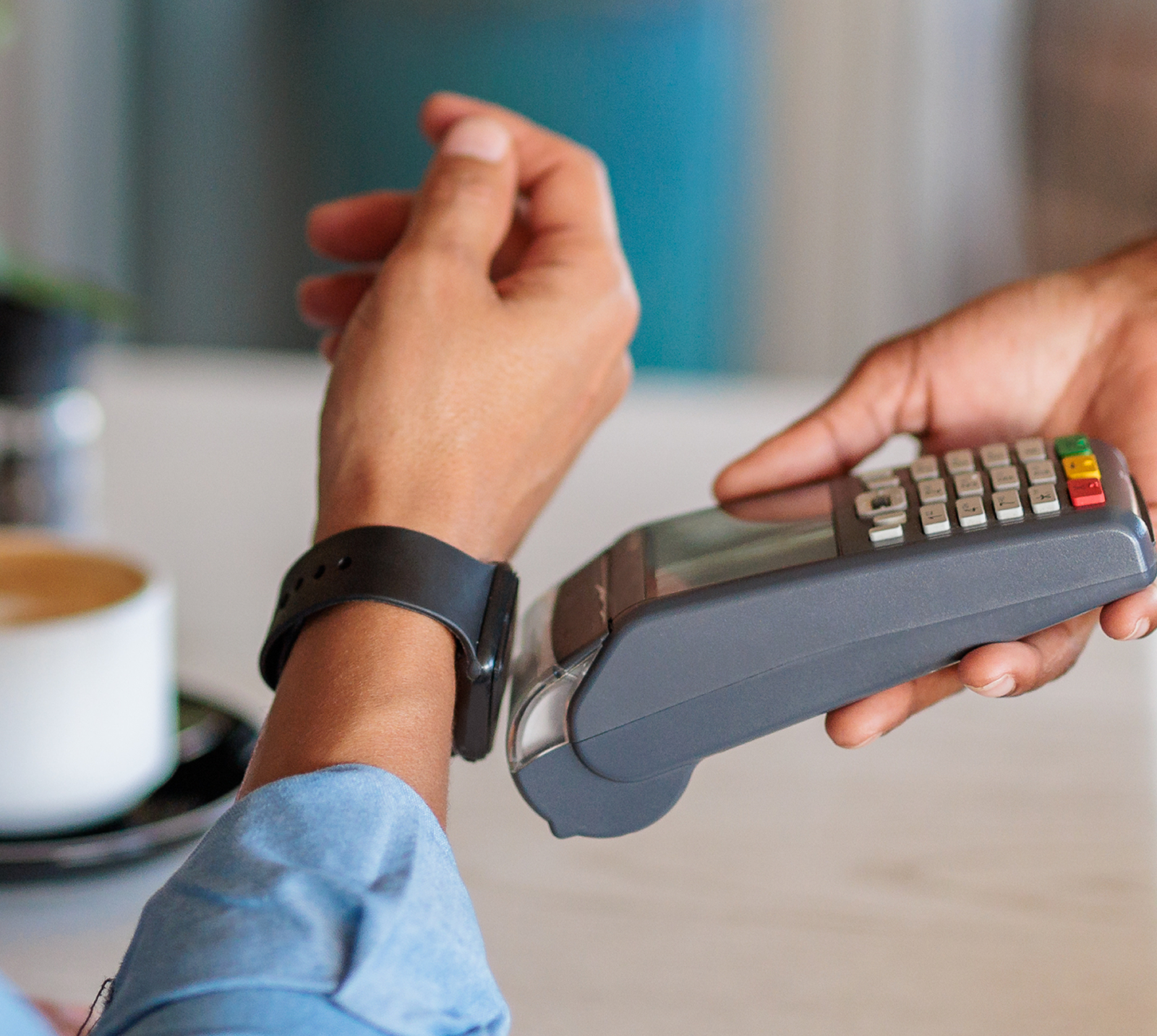 Customer tapping their smart watch against a card reader