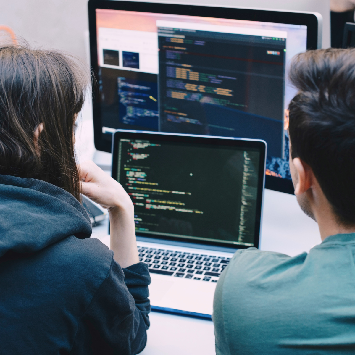 Associate looking at a laptop screen with code